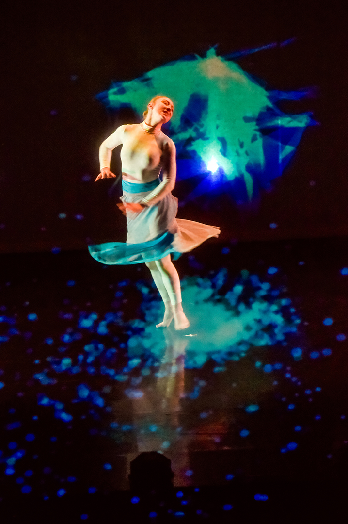 ESDC Louisa spinning in a swirl of teal flares and polygonal trails during Kaatsbaan residency.